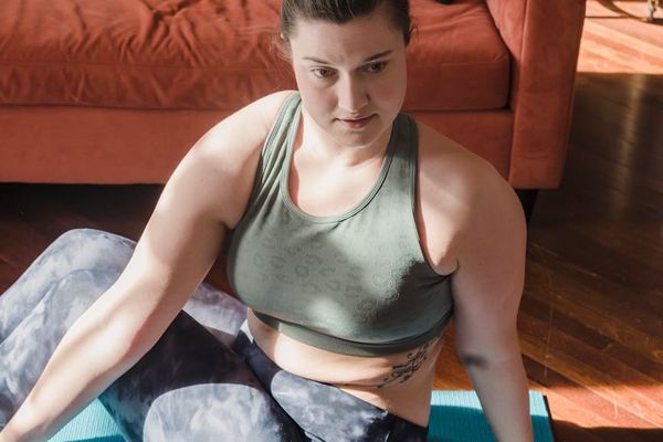 Person doing yoga stretch in a minimal room