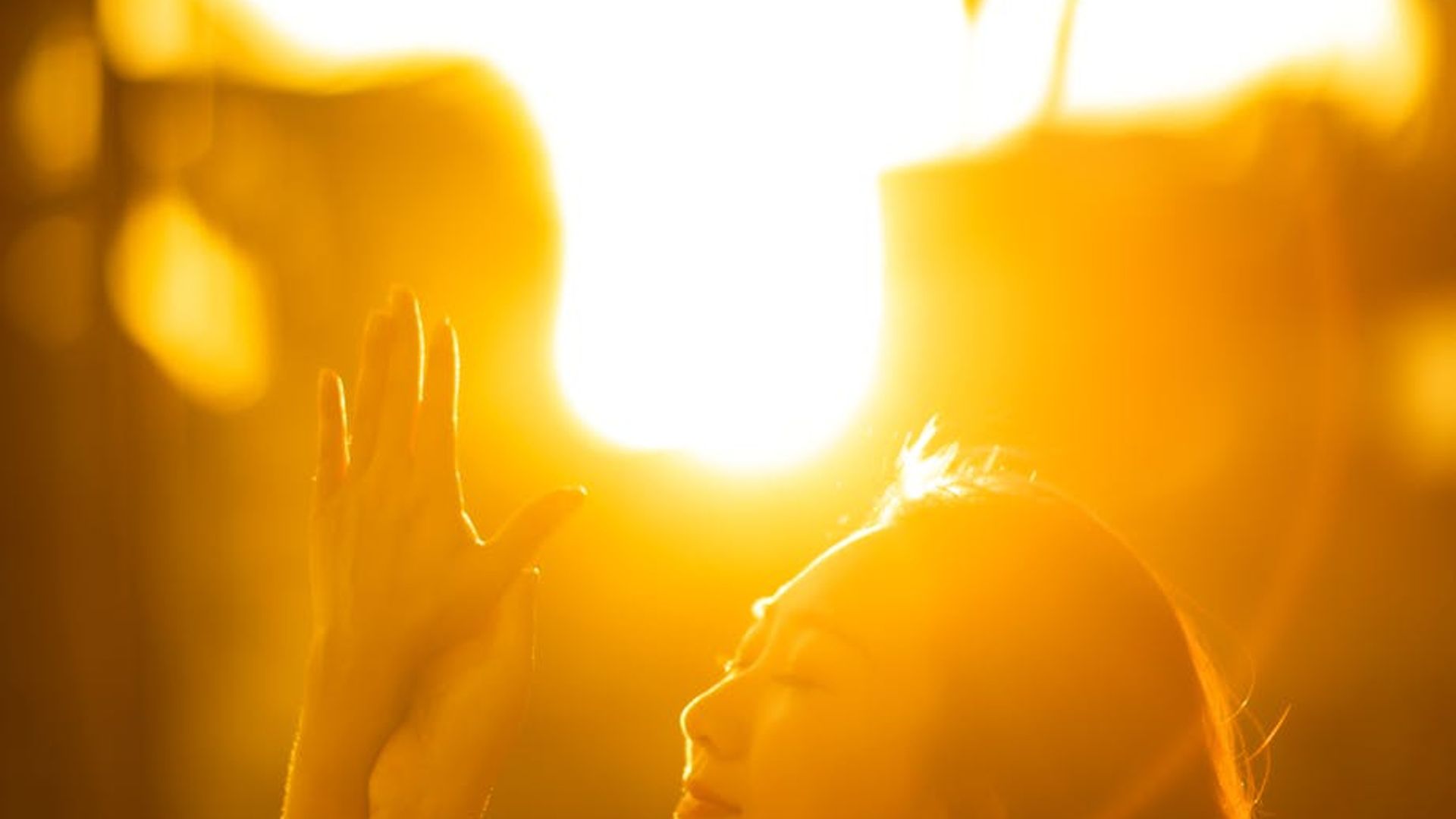 Serene woman practicing yoga at sunrise in nature